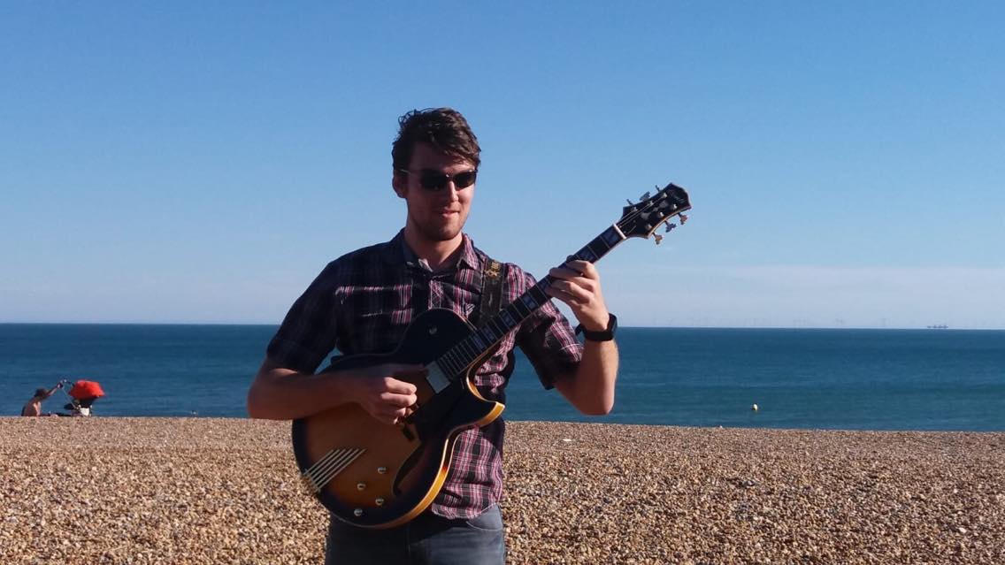 James Hopkins on the beach with his new Sunburst Conti Entrada Archtop Guitar