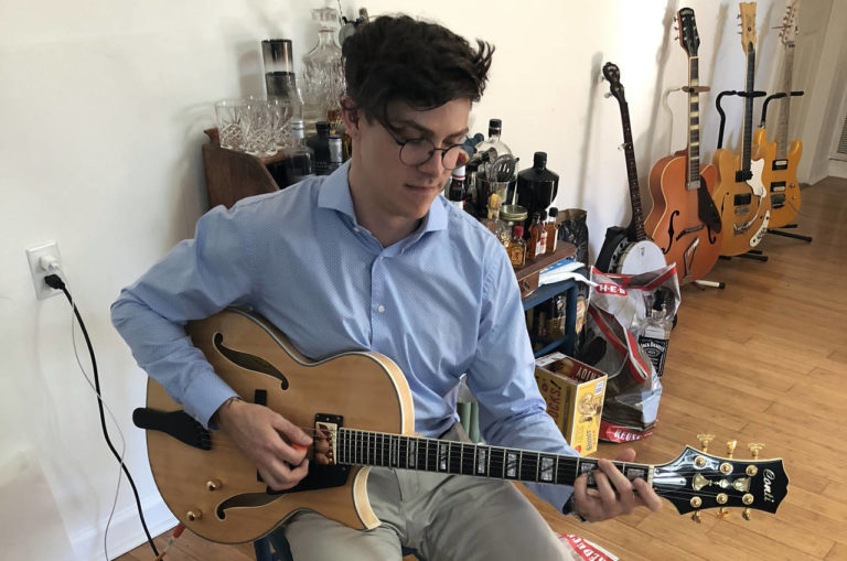 Photo of Harrison Root with his natural blonde Conti Entrada Archtop Guitar