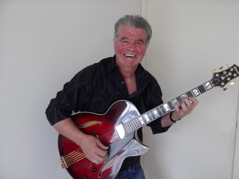 Mike Powell with his Ruby Red Conti Heirloom Archtop Guitar