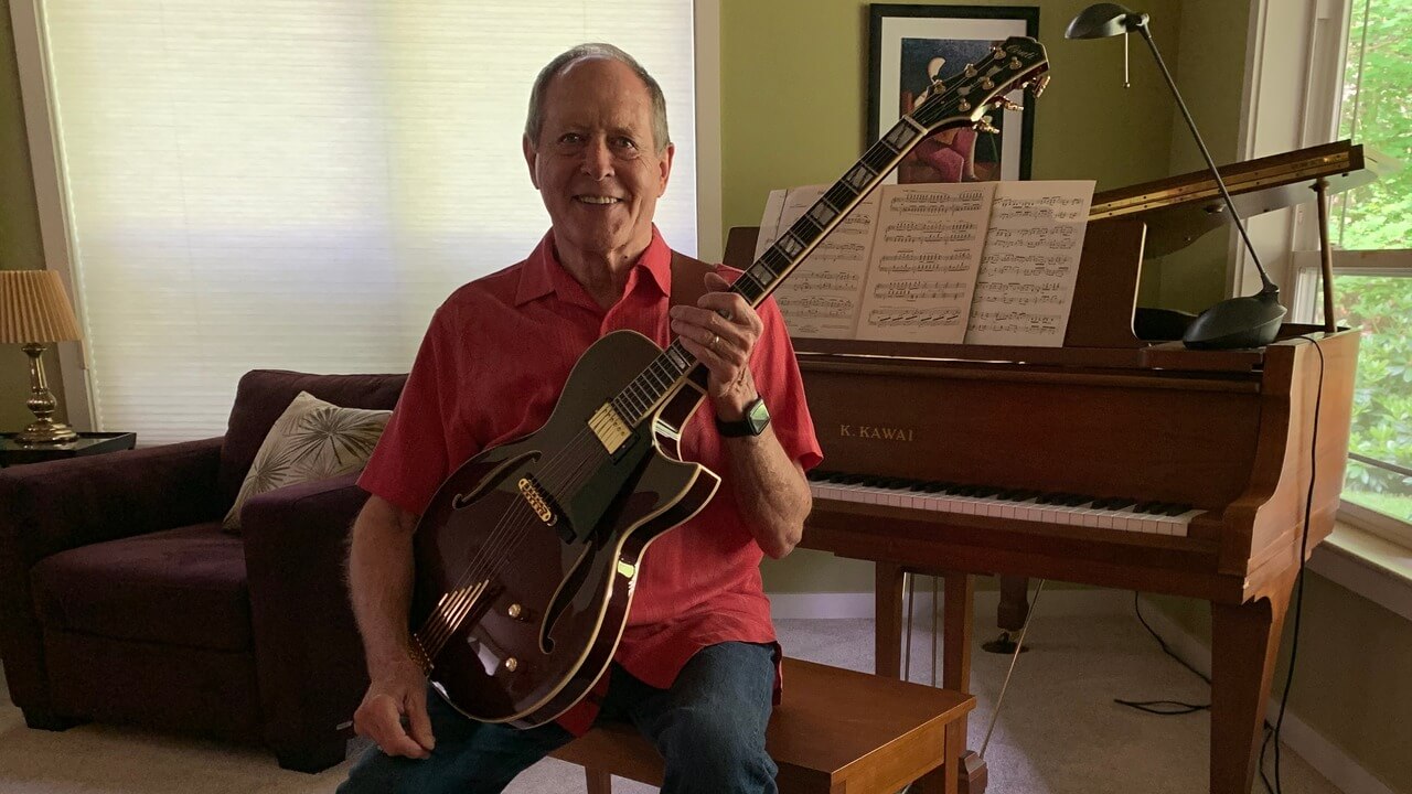 Mike Coile sits proudly with his brand new Conti Entrada archtop jazz guitar in Port Wine finish