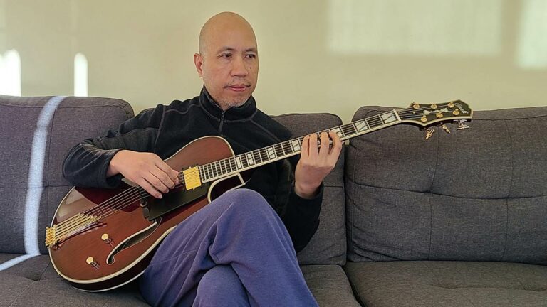 Howard Jao sits with his new Conti Entrada in Port Wine, 15 inch body